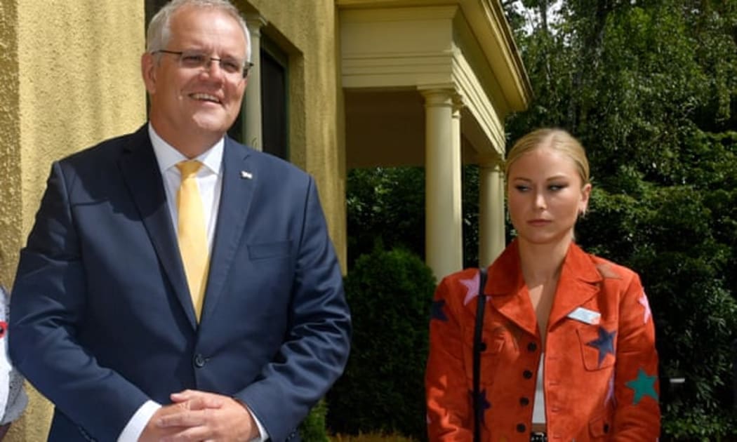 Grace Tame appears visibly uncomfortable as she stands for a picture with Scott Morrison