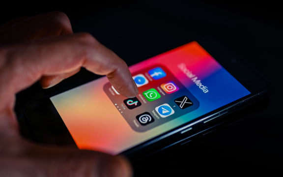 Close - up finger pointing to TokTok mobile app displayed on a smartphone screen alongside that of X,Whatsapp,Facebook,Messenger,Threads,Telegram, on August 15, 2023, in Brussels, Belgium. (Photo illustration by Jonathan Raa/NurPhoto) (Photo by Jonathan Raa / NurPhoto / NurPhoto via AFP)