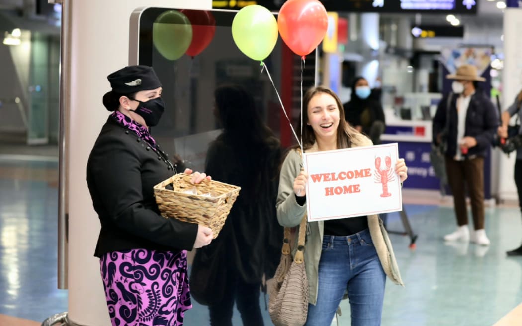 Travellers are welcomed at Auckland airport as international tourists from visa-waiver countries return to New Zealand, 2 May 2022.