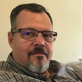 Middle aged man with goatee and glasses