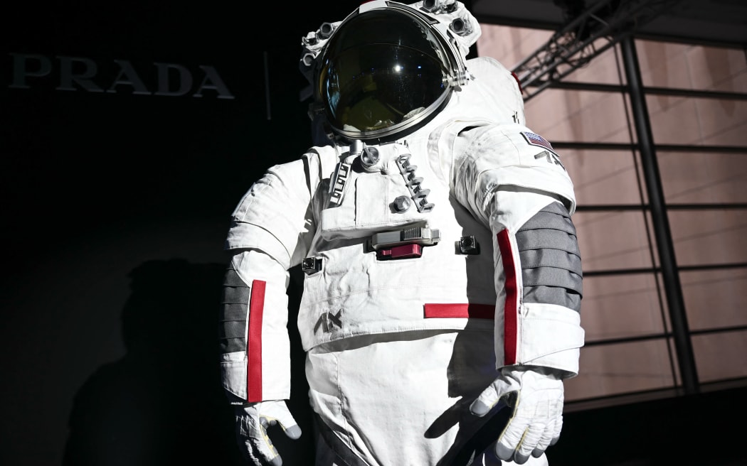The AxEMU suit is pictured during a press conference of Prada and Axiom Space, as part of the presentation of the Axiom Extravehicular Mobility Unit designed and developed for the Artemis 3 lunar mission in collaboration with Prada, at the MiCo Convention Centre in Milan, northern Italy, on October 16, 2024. - Astronauts walking on the moon as part of NASA's first human mission to the lunar South Pole will be wearing Prada, as part of a new venture unveiled on October 16, 2024. Private space company Axiom Space teamed up with the Italian luxury brand to provide the surface suits and spacewalk systems for NASA's Artemis 3 mission, which is planned for September 2026. (Photo by MARCO BERTORELLO / AFP)