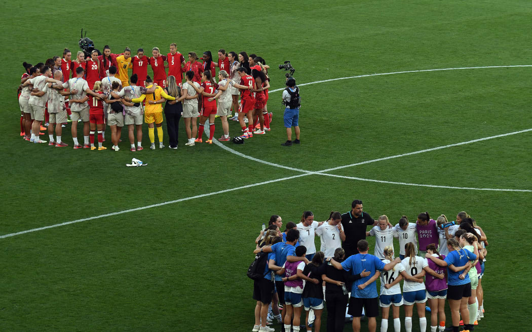 Both teams huddle up after Canada beat the Football Ferns 2-1 at the Paris Olympics.