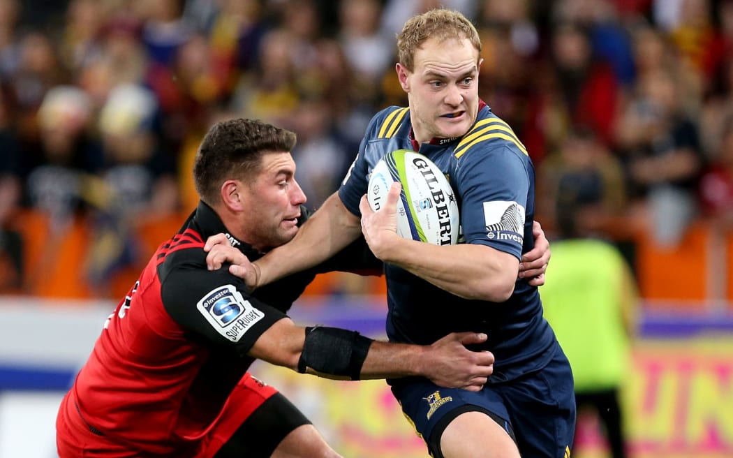 Highlanders centre Matt Faddes bursts past his Crusaders opposite Kieron Fonotia.