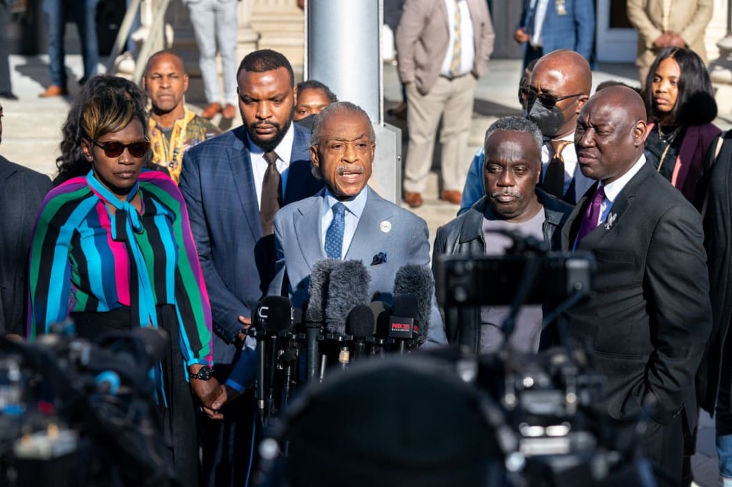 Rev. Al Sharpton, center, with Wanda Cooper-Jones, mother of Ahmaud Arbery, left, attorney Lee Merritt, second from left, attorney Ben Crump, right, and Marcus Arbery, father of Ahmaud Arbery, address members of the media.