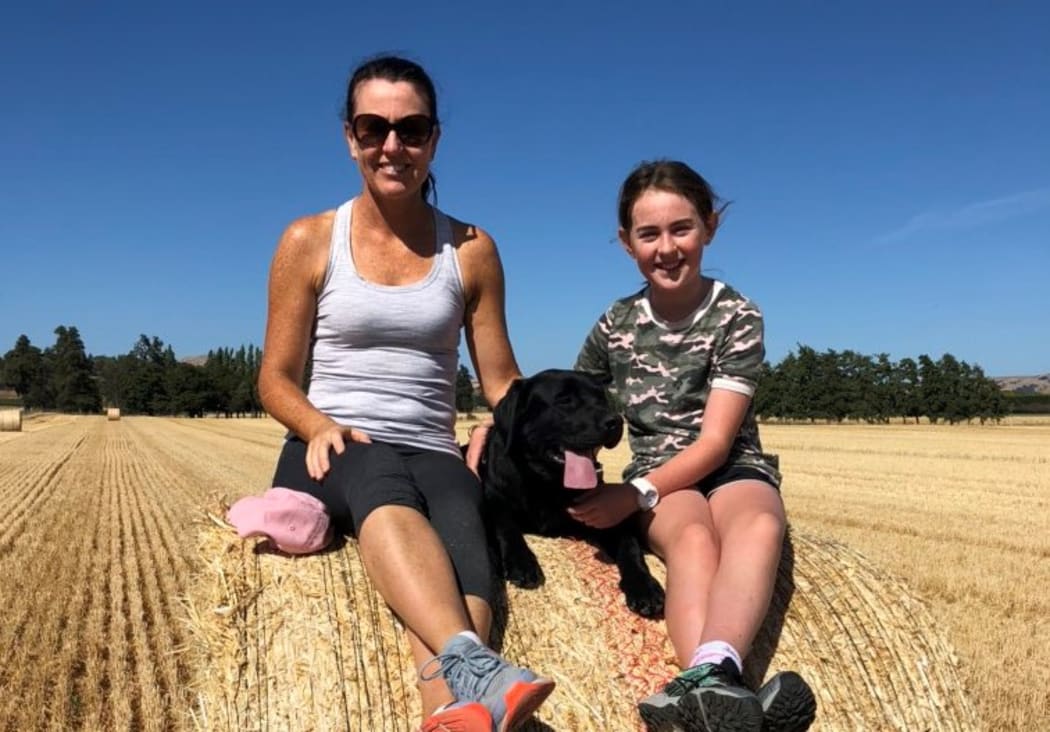 Karen Williams with her daughter and lab after barley straw harvest