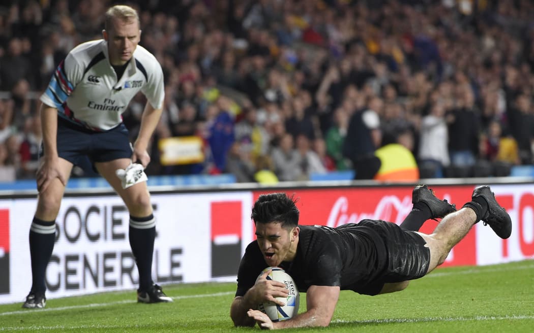 Nehe Milner-Skudder scores the first try during the final match of the 2015 Rugby World Cup, as touch judge Wayne Barnes looks on.