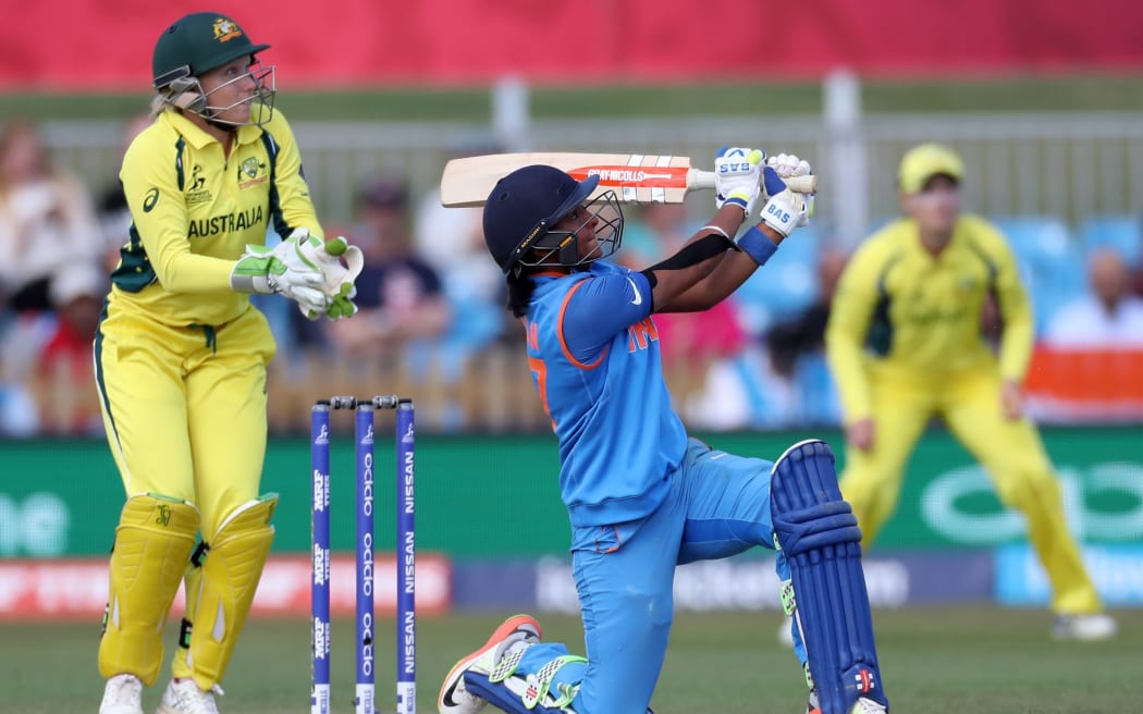 Harmanpreet Kaur hits a six during her century in the Women's World Cup semi-final between Australia and India.
