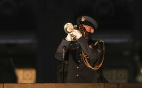 Bugler Corporal Keiran Smith plays the last post.