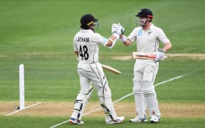 New Zealand opening batsman Tom Latham celebrates his century with henry Nicholls on Day 1. 2nd Test match. New Zealand Black Caps v England. International Cricket at Seddon Park, Hamilton, New Zealand. Friday 29 November 2019