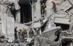 Emergency workers check the damage caused to a building from an Iranian missile strike in Beersheba in southern Israel.