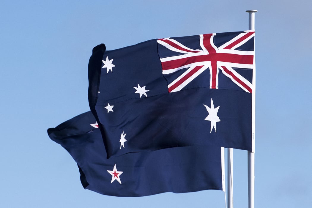 The Australian (R) and New Zealand flags fly during the dedication of the Australia ANZAC memorial at Pukeahu National War Memorial Park in Wellington, New Zealand on APRIL 20, 2015.   AFP PHOTO / MARTY MELVILLE (Photo by Marty MELVILLE / AFP)