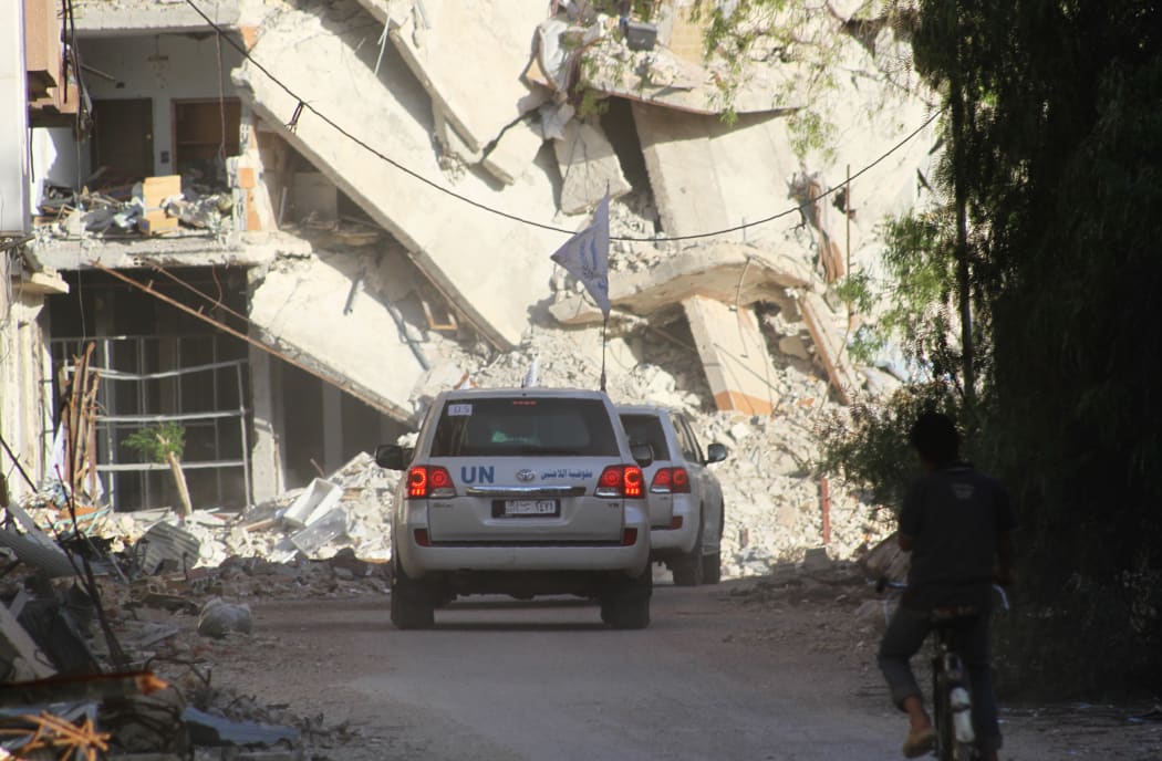 United Nations vehicles drive as an aid convoy entered the rebel-held Syrian town of Daraya.