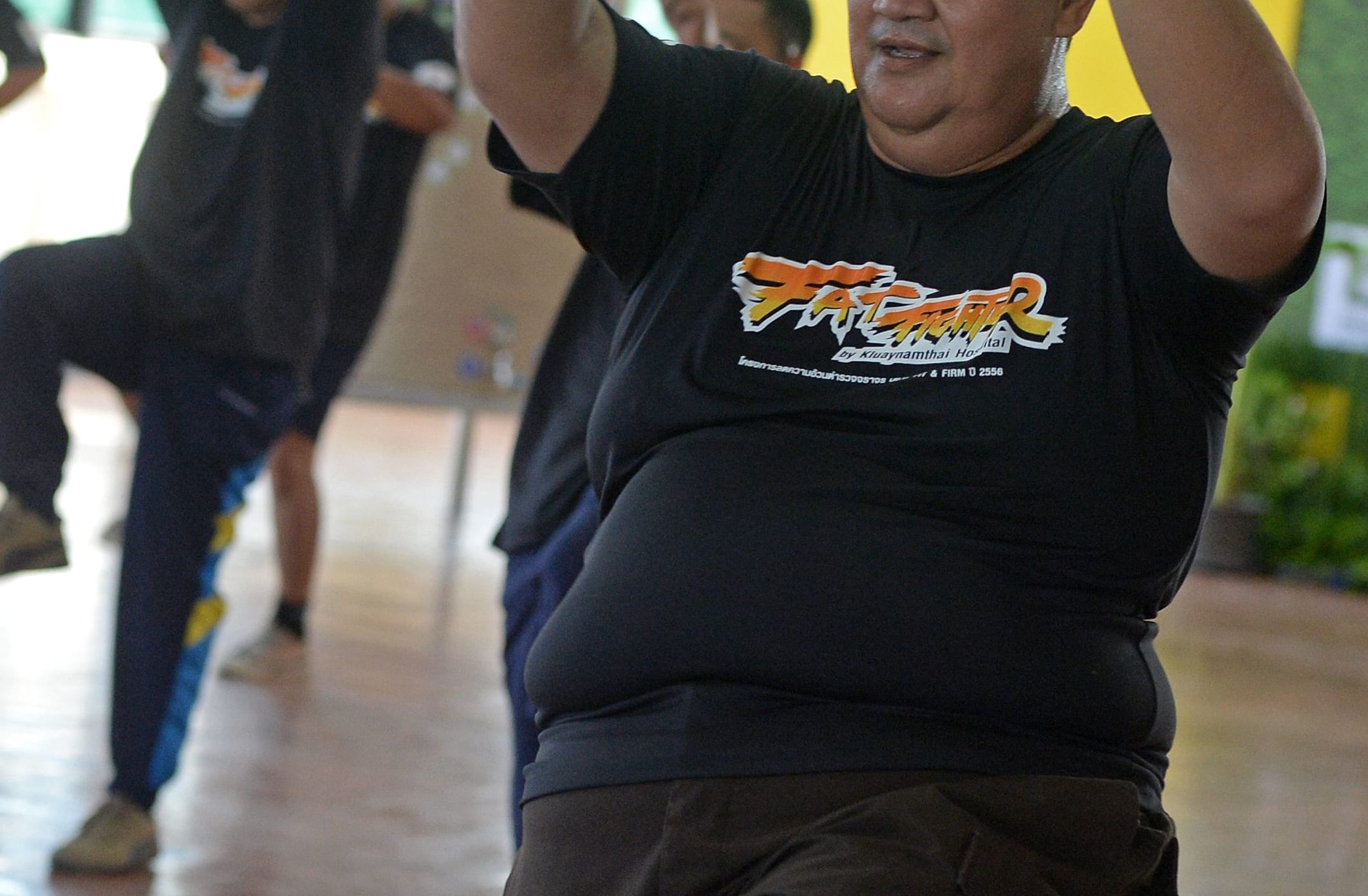 exercise programme at hospital in Bangkok. Dozens of sweaty  cops exercise to  pop songs as part of a scheme to reduce the number of overweight police in Bangkok.