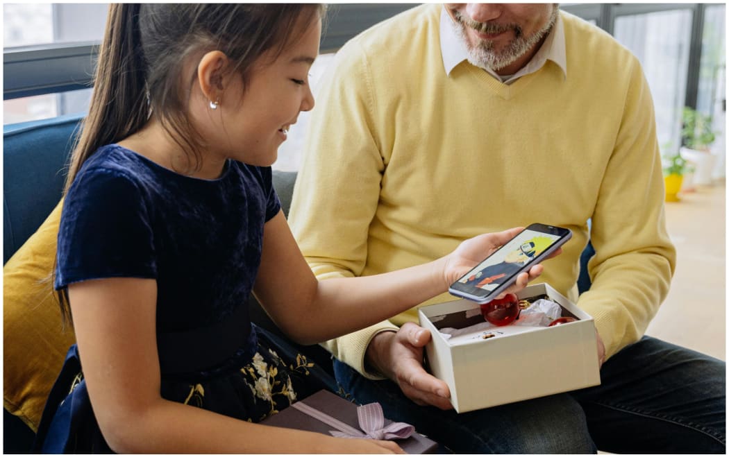Image of girl receiving smartphone gift