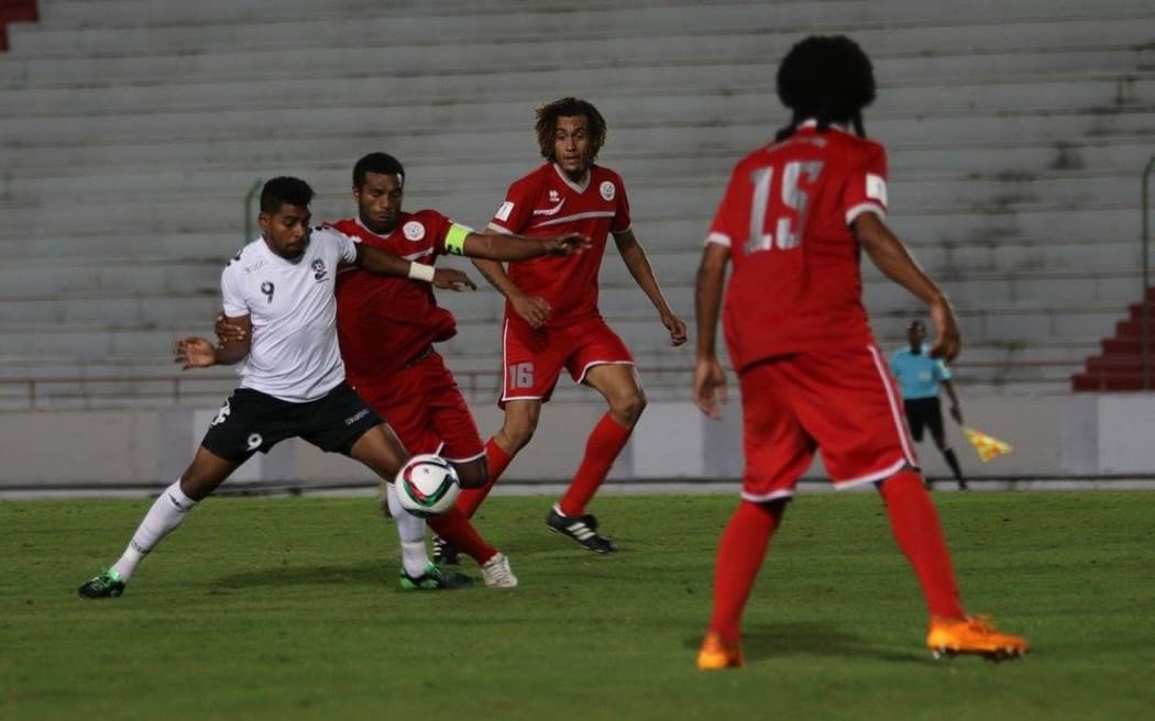 Roy Krishna is surrounded by New Caledonia defenders.