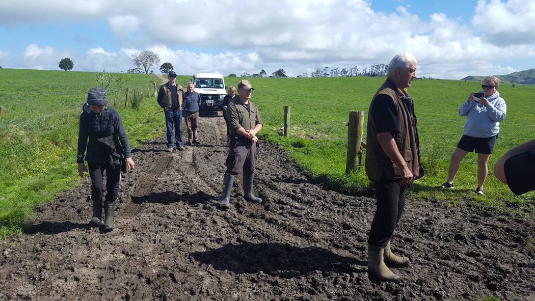 Kaumatua Pita Cherrington offers a karakia before hapū members head down to their old eeling reserve thru muddy pasture.