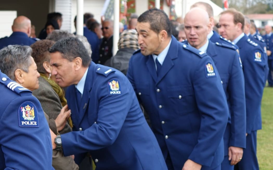 Officers greet people  at Te Rewarewa Marae.