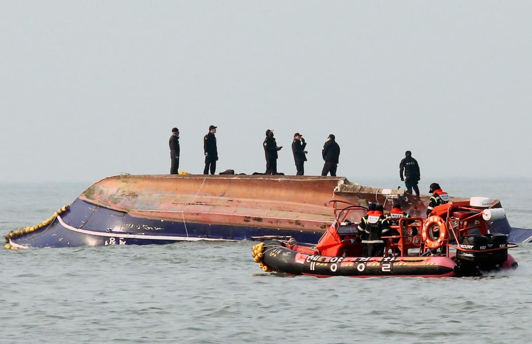 South Korean coastguard members search for missing persons after a fishing boat crashed with a fuel tanker at sea near the western port city of Incheon on December 3, 2017.