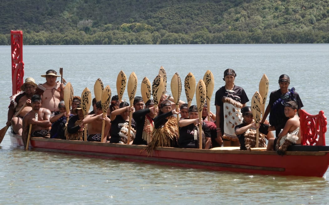 The crew of the waka Mai Pewhairangi perform a salute.