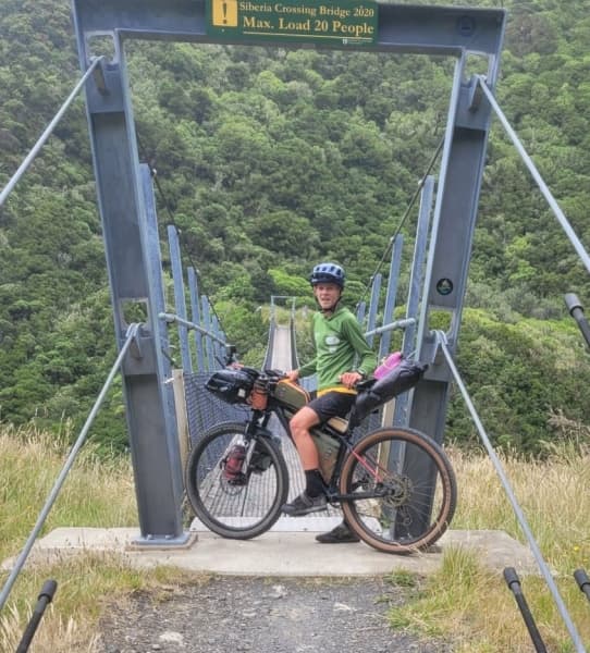 Mahe Braaksma, 14, stops on his bike before crossing a trail bridge.