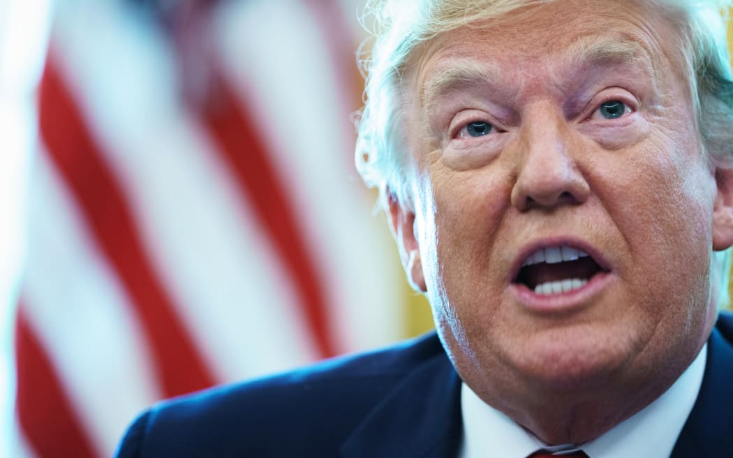 US President Donald Trump in the Oval Office before signing an executive order for sanctions on Iran's supreme leader.