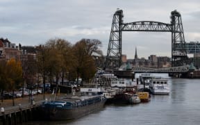 The Koningshavenbrug 'De Hef" lift bridge (R, rear) and the Koninginnebrug drawbridge (R, front) are seen in the background in Rotterdam, western Netherlands, on 23 November, 2021.