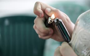 A male smoking using a homemade bong