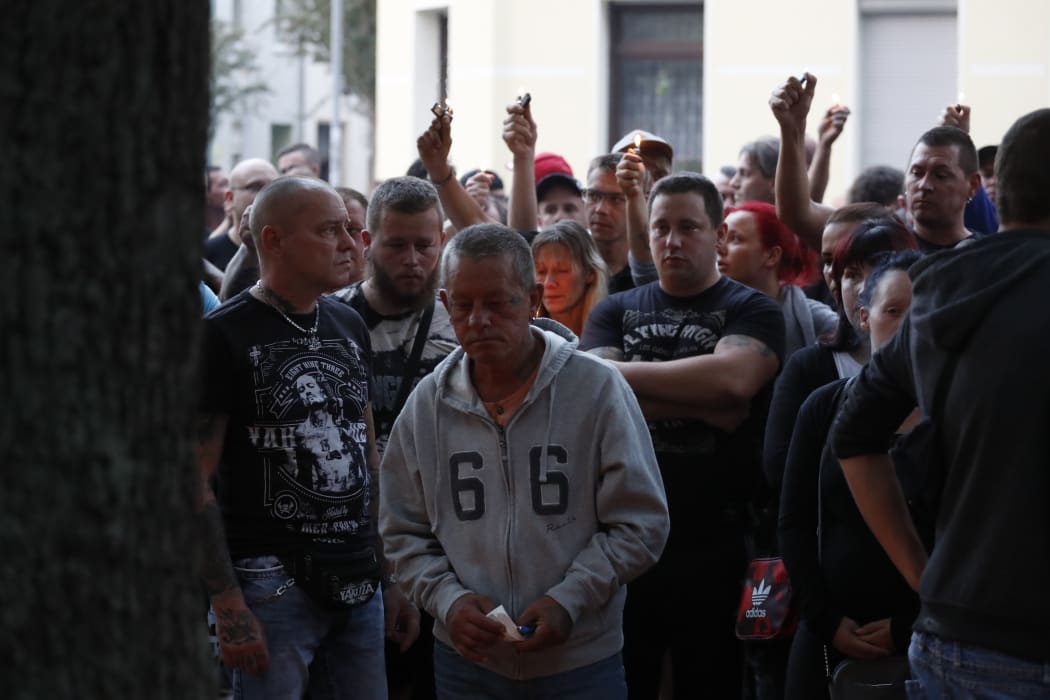 People with lighters are pictured after a mourning march in Koethen, eastern Germany, on September 9, 2018.