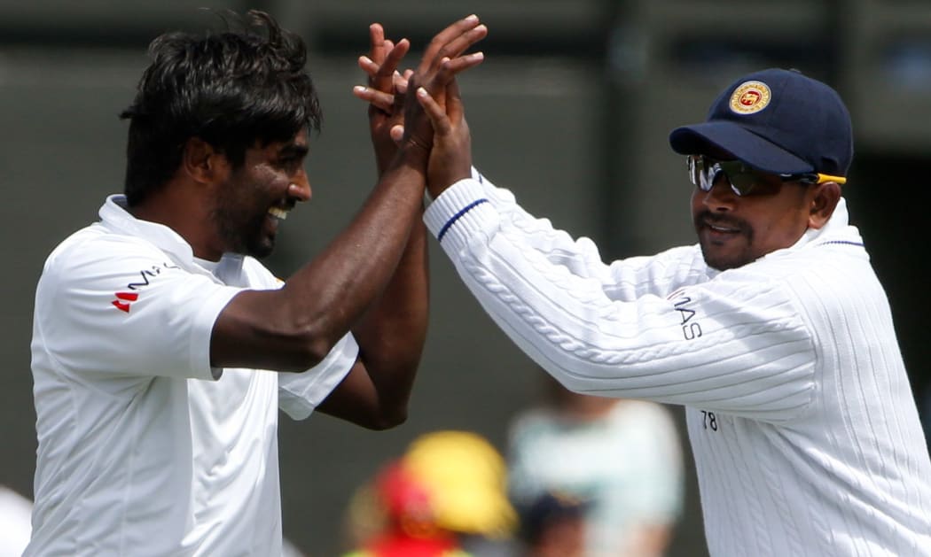 Sri Lanka's Nuwan Pradeep, left, celebrates with Rangana Herath after a wicket.