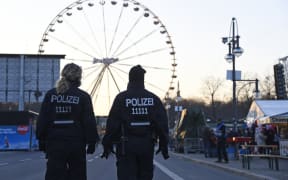 Police patrol at the fair grounds ahead of the New Year's Eve party near the Brandenburg Gate in Berlin.