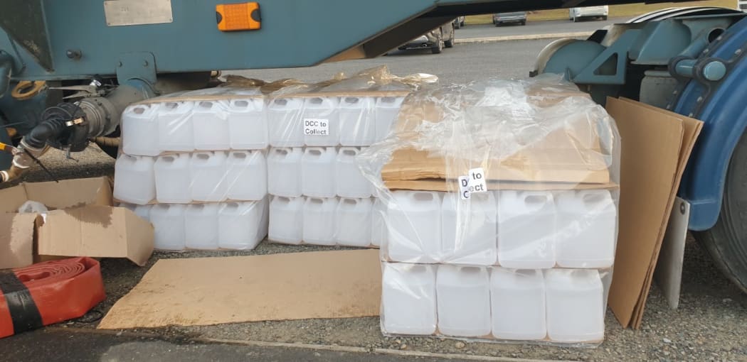 Containers for water near a tanker in Waikouaiti where high lead levels were discovered in the water supply.