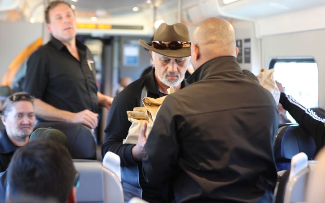 The first train to Taupiri Maunga from the Māori king's tangi. Manaakitanga shown by the Te Huia staff handing out kai packs and water.