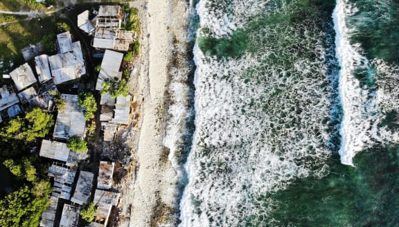 Coastal homes in Tuvalu, Funafuti pictured on November 28, 2019. The low-lying South Pacific island nation of about 11,000 people has been classified as "extremely vulnerable" to climate change by the United Nations Development Programme due to rising sea levels.
