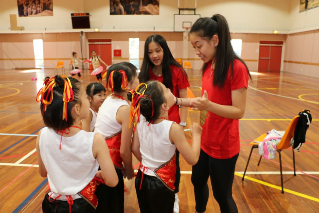Jacqueline Tom (right) passes on her dance skills