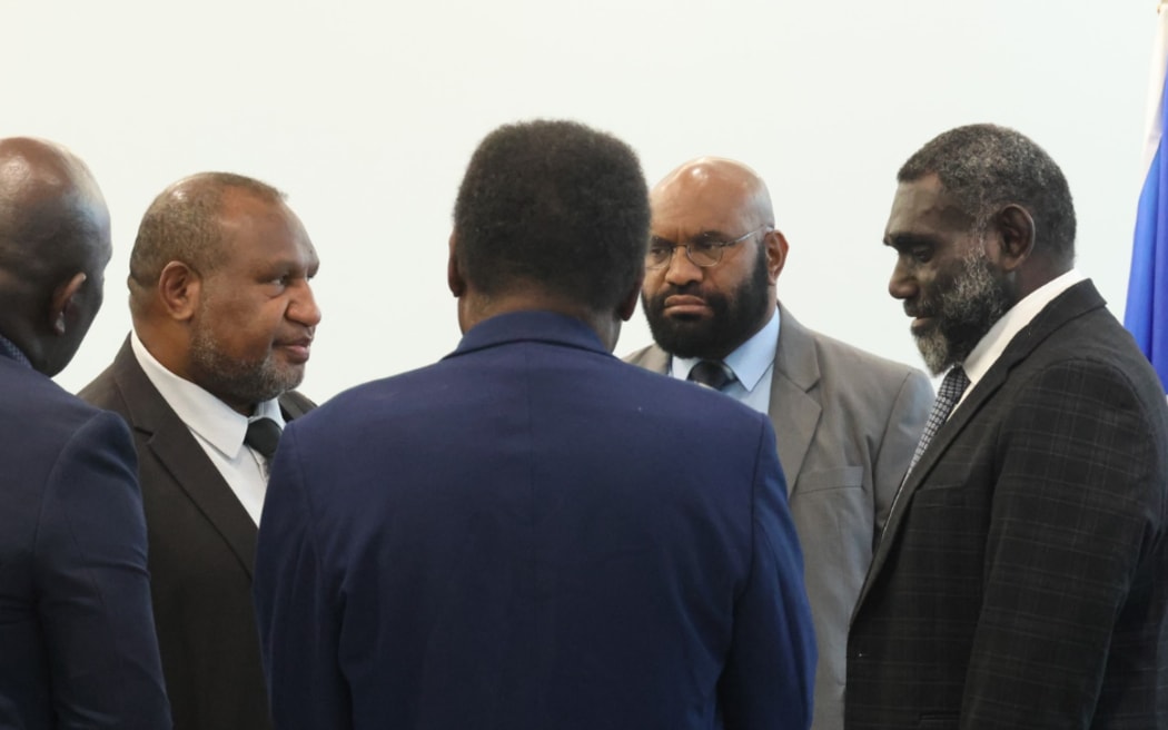 James Marape, second left, and Ishmael Toroama, right, during the joint moderations talks in Port Moresby
