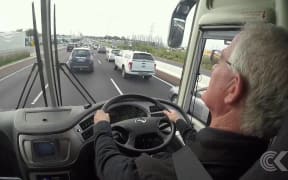 Auckland mayoral candidates take bus ride with John Campbell