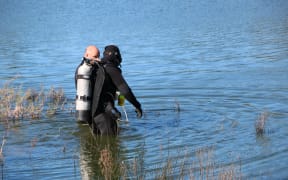 Divers going into the lake at Westlake Reserve, 13 September 2017.