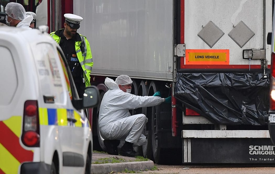 British Police forensics officers work on lorry, found to be containing 39 dead bodies, at Waterglade Industrial Park in Grays, east of London.