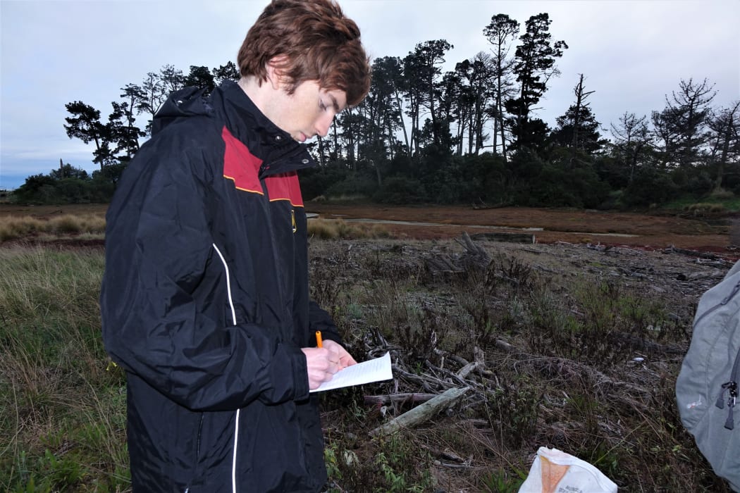 Finn Fidler recording details of trapping on Haulashore for the national database.