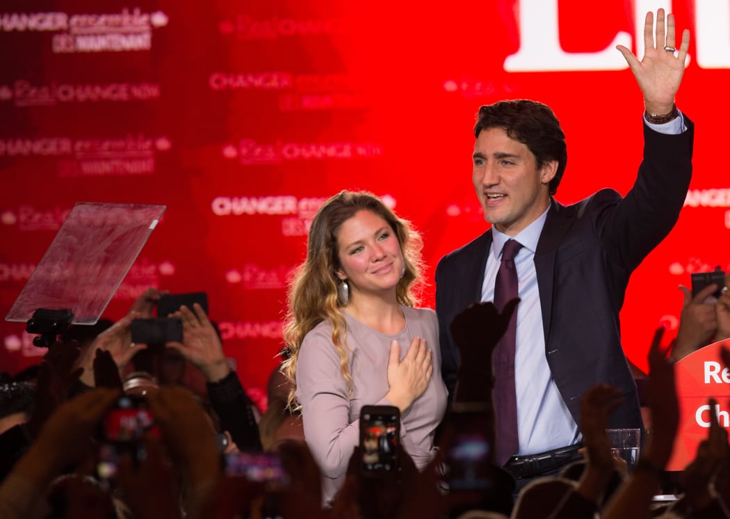 Canadian Liberal Party leader Justin Trudeau and his wife Sophie wave on stage in Montreal on 20 October 2015 after winning the general election.