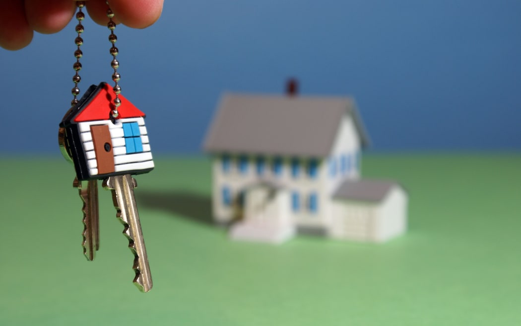 An illustration showing a hand holding keys to a new home.