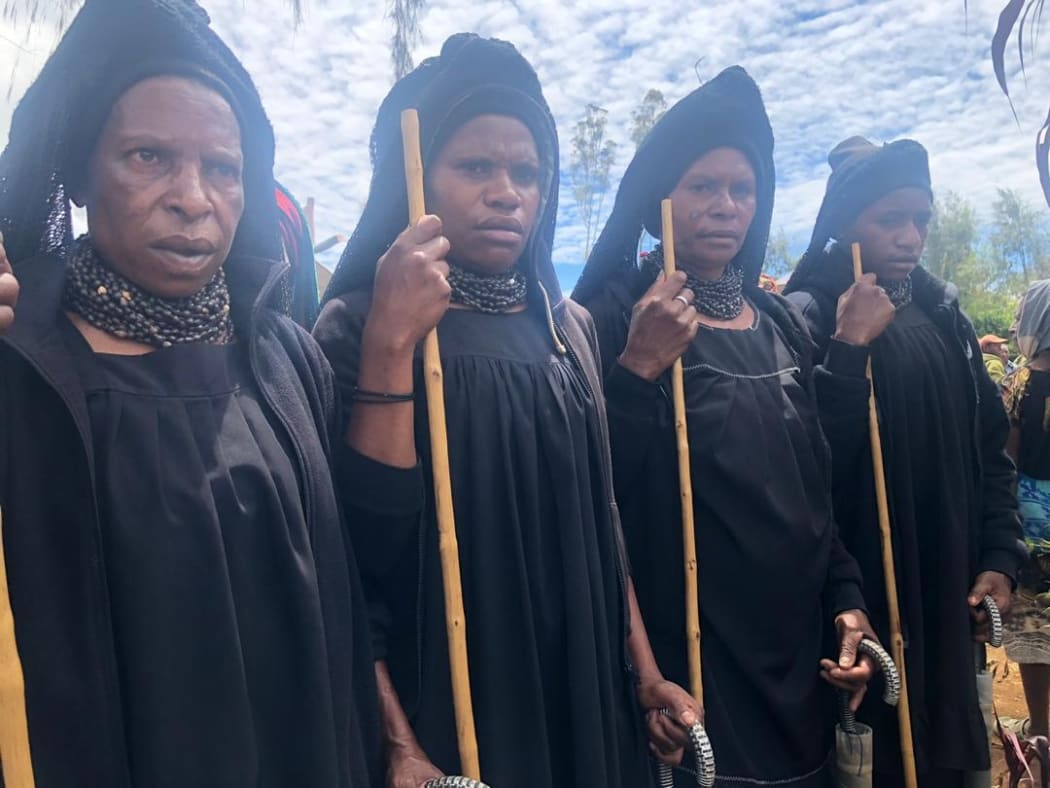 Highlands women attend a funeral for a victim of a sorcery accusation-related attack
