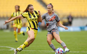 Shea Connors of Brisbane Roar and Mackenzie Barry of the Phoenix.