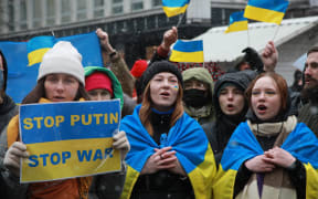 People, holding banners and flags, gather to hold a solidarity protest against Russia's attacks on Ukraine in Belgrade, Serbia on 6 March 2022.
