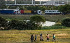 Migrants try to enter inside the Eurotunnel site to attempt to reach Britain, in Coquelles near Calais, northern France, on July 31, 2015.