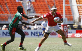 Tonga's Tana Fotofili evades the Kenyan defence in Sydney.
