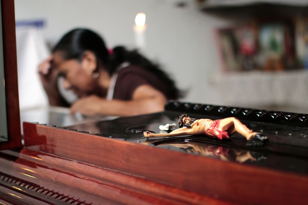 A woman attends Miguel Angel Jimenez Blanco's wake in Xaltianguis, Guerrero State, Mexico, on 9 August.