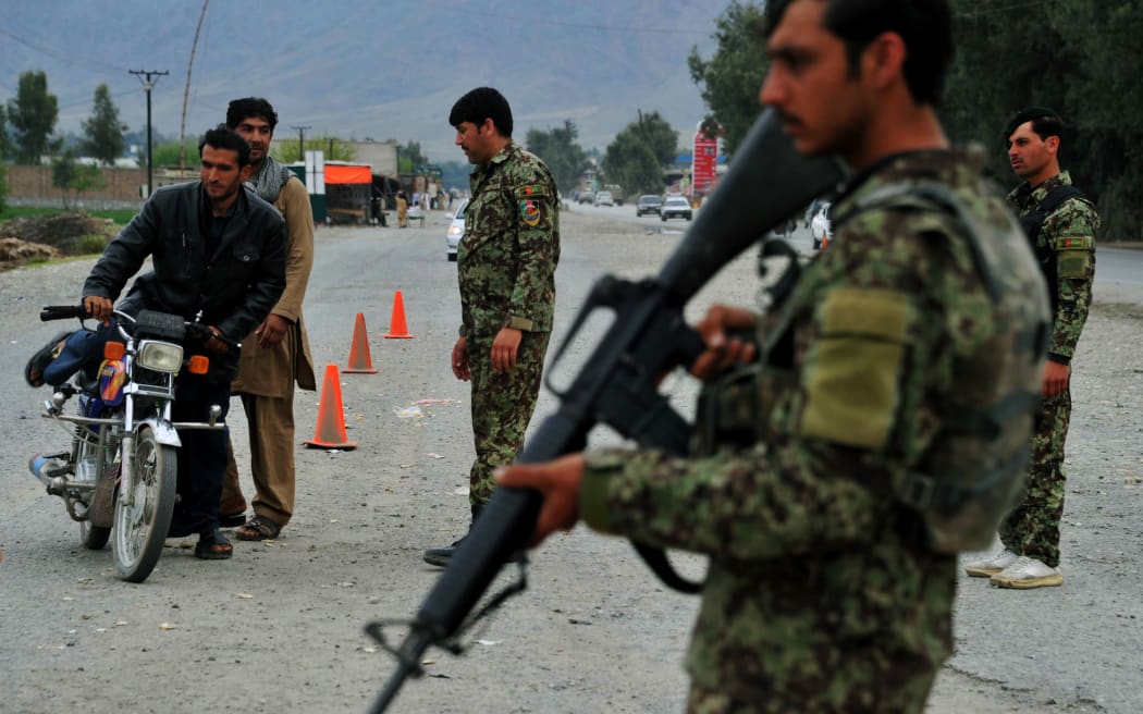 Travellers halt at a checkpoint in Jalalabad.