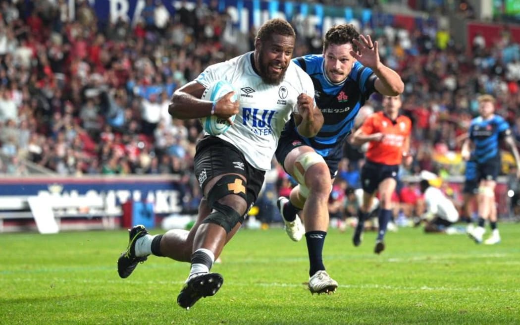 Flying Fijians captain Tevita Ikanivere on his way to scoring his try against Japan.