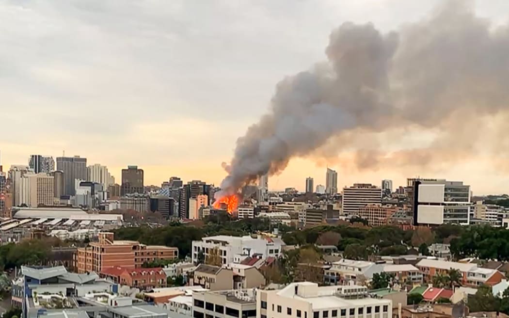This screen grab from a UGC video taken and posted by Michael Goode on Facebook on May 25, 2023 shows a fire in central Sydney. More than 100 firefighters battled towering flames and thick smoke from a seven-storey blaze in central Sydney on May 25 that was spreading to other buildings. (Photo by Michael GOODE / Facebook page of Michael Goode / AFP) / -----EDITORS NOTE --- RESTRICTED TO EDITORIAL USE - MANDATORY CREDIT "AFP PHOTO / Facebook page of Michael Goode / Michael Goode  " - NO MARKETING - NO ADVERTISING CAMPAIGNS - DISTRIBUTED AS A SERVICE TO CLIENTS